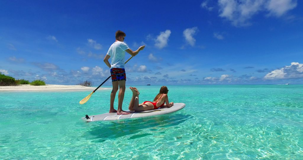 Couple Paddle boarding in the Maldives
